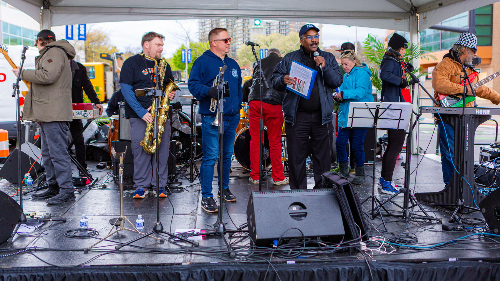 The event emcee is joined on stage by a big band. 