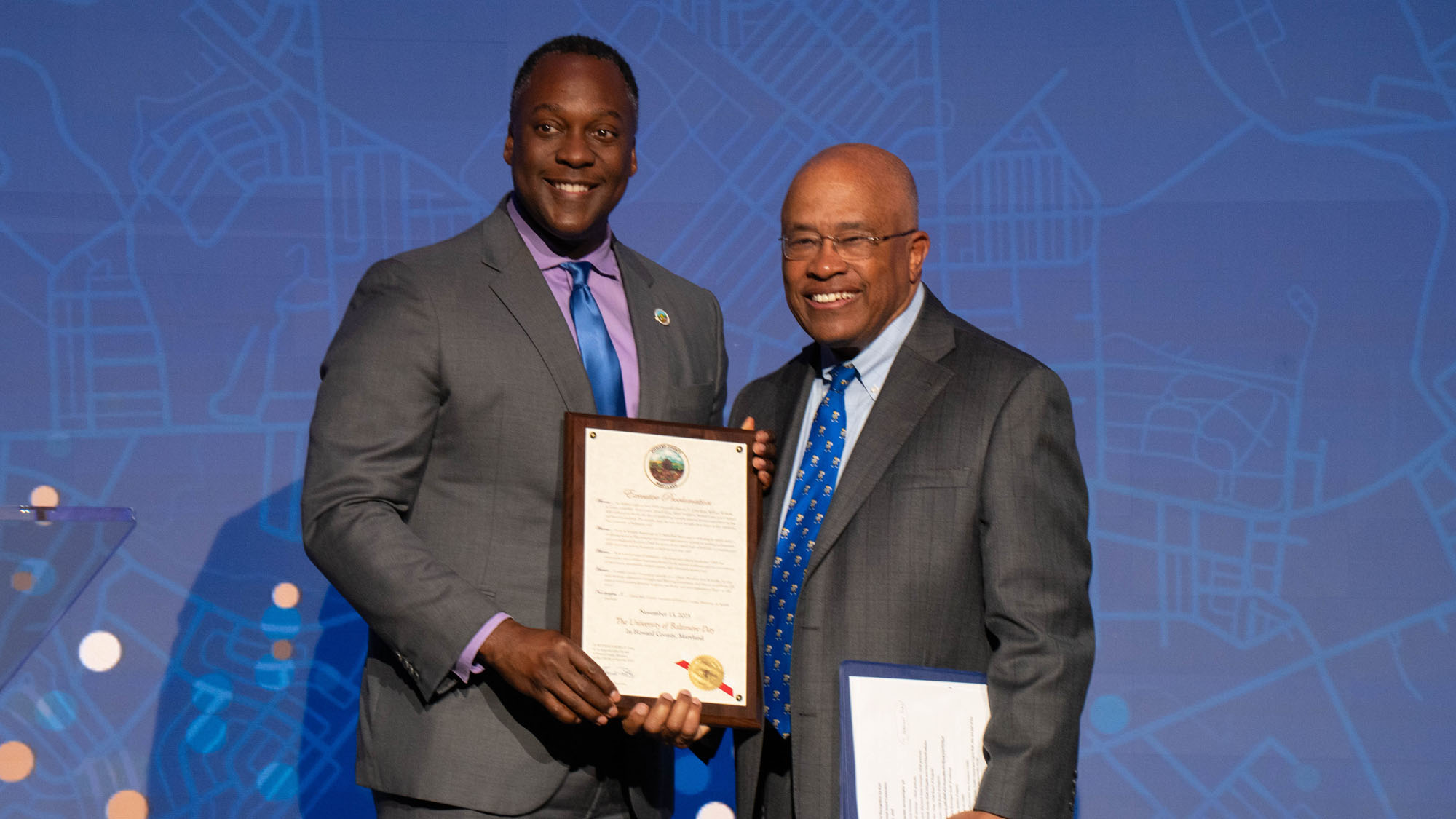Calvin Ball, M.A. '99, Howard County Executive, presents a citation honoring the University for its milestone.&nbsp;