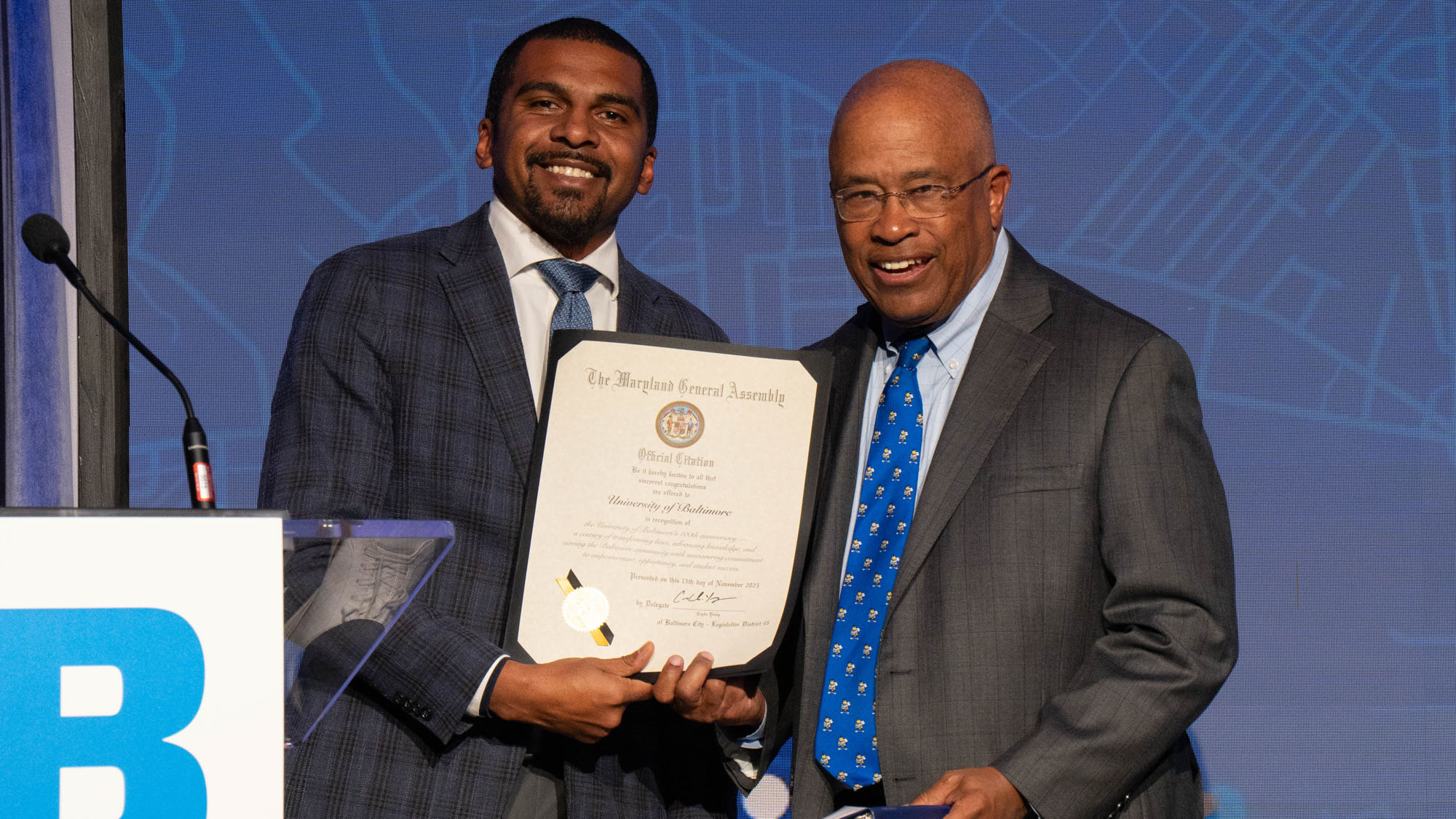 Caylin Young, J.D. '16, Maryland State Delegate, presents a citation to UBalt President Kurt L. Schmoke.&nbsp;