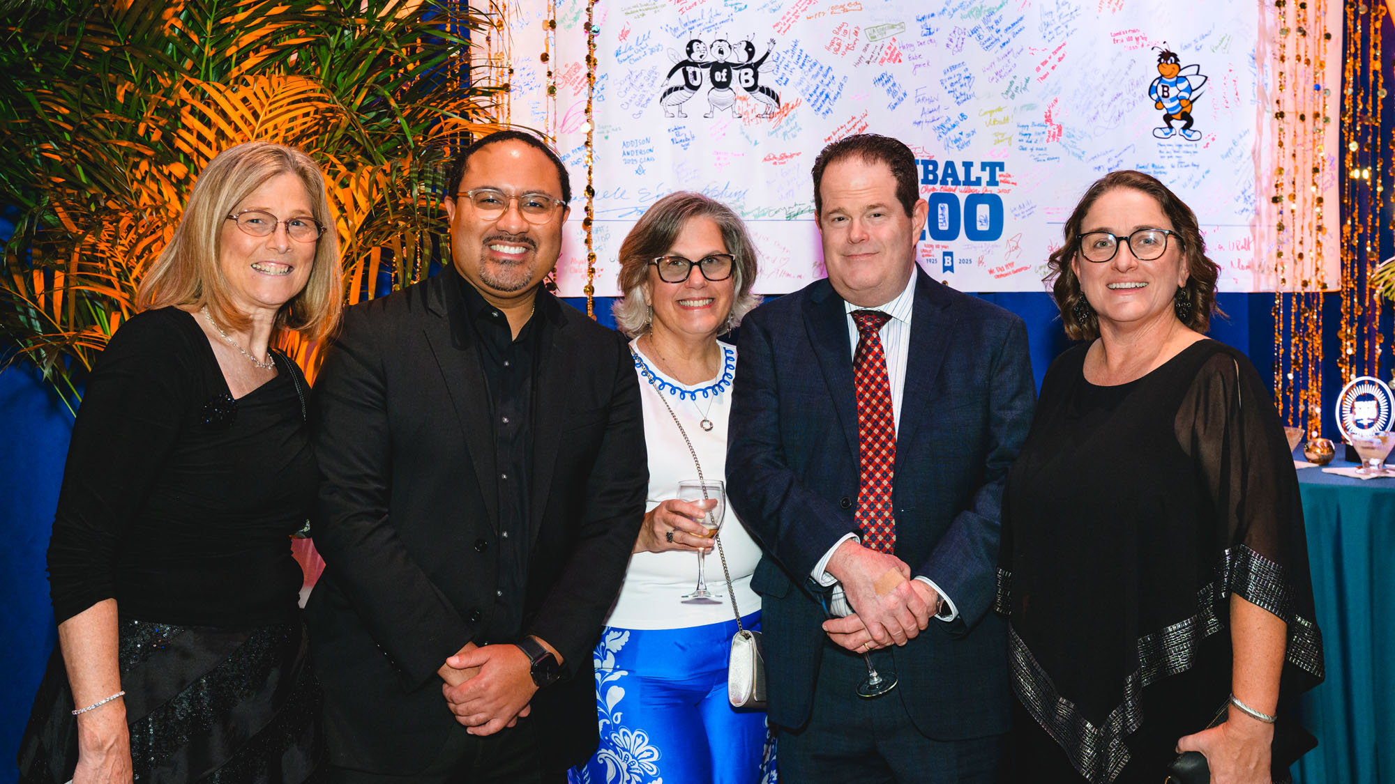 Five people pose for a photo during the celebration.