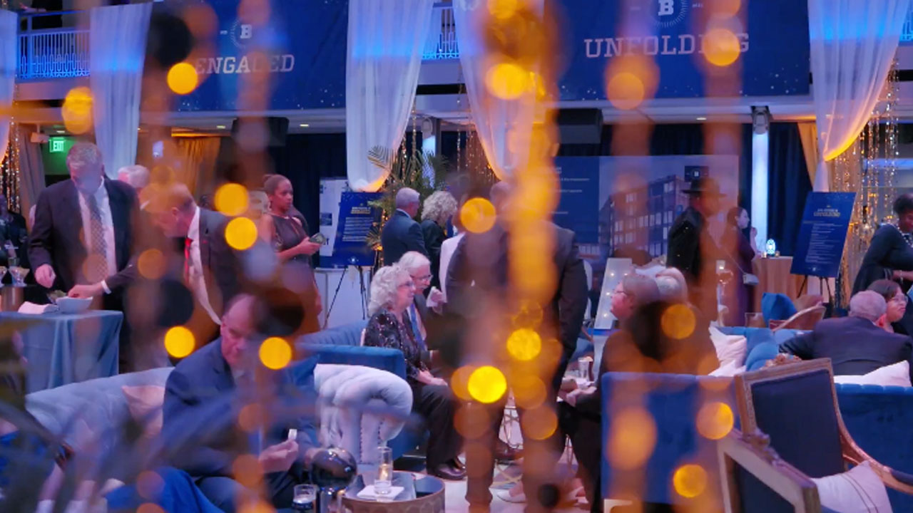 A scene from the celebration unfolds with natural framing of a exhibit