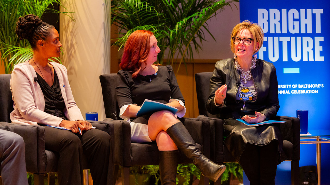 Joan Worthington answers a question during the Community Conversation panel discussion while Jessica Stansbury and Rebekah Opher look on.
