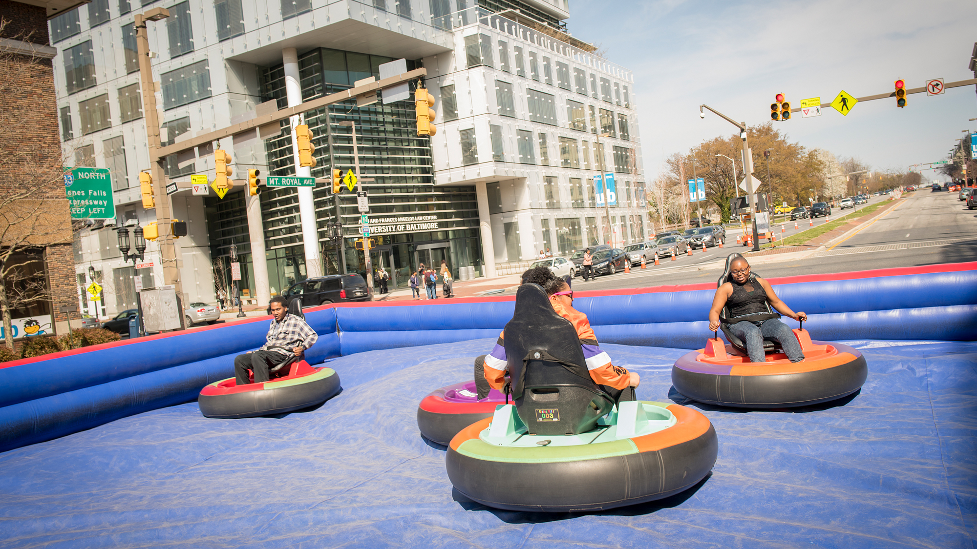 Students drive bumper cars on Mount Royal Avenue.