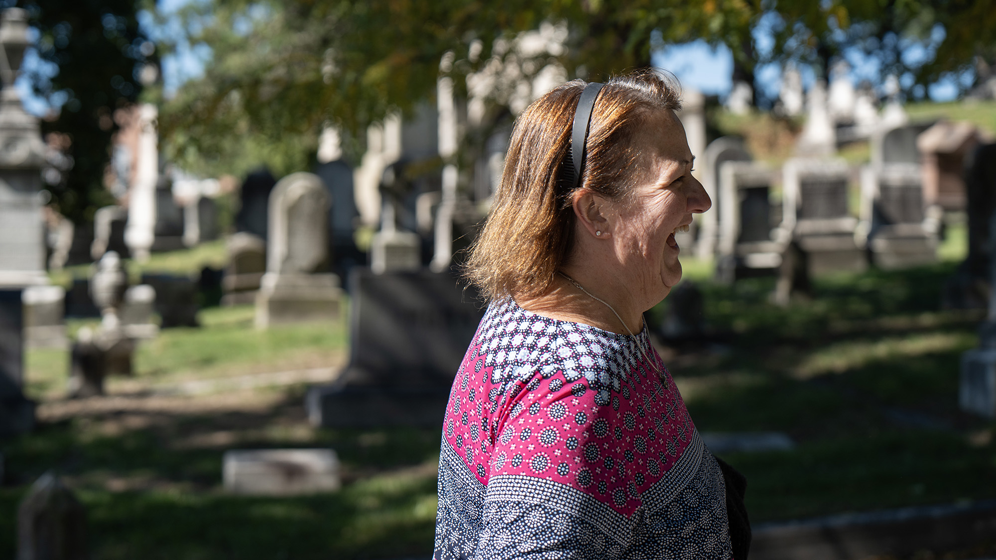 Cindy Schuster laughs while walking outside