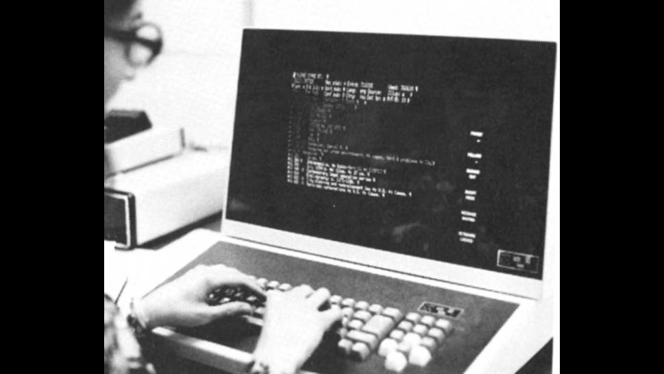 A student works on a computer in the 1970s.