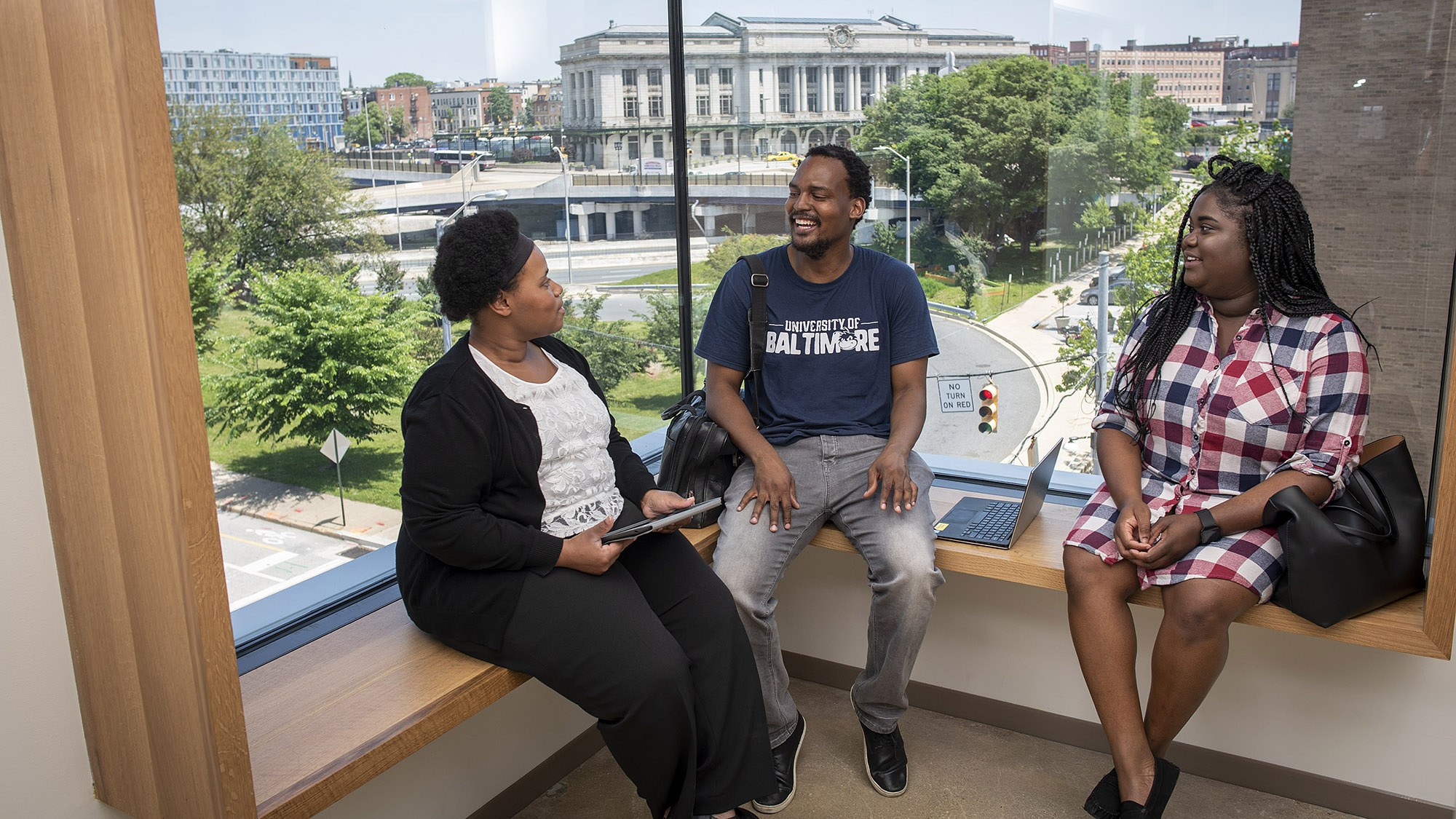 Students sit in a window bench in today's library.