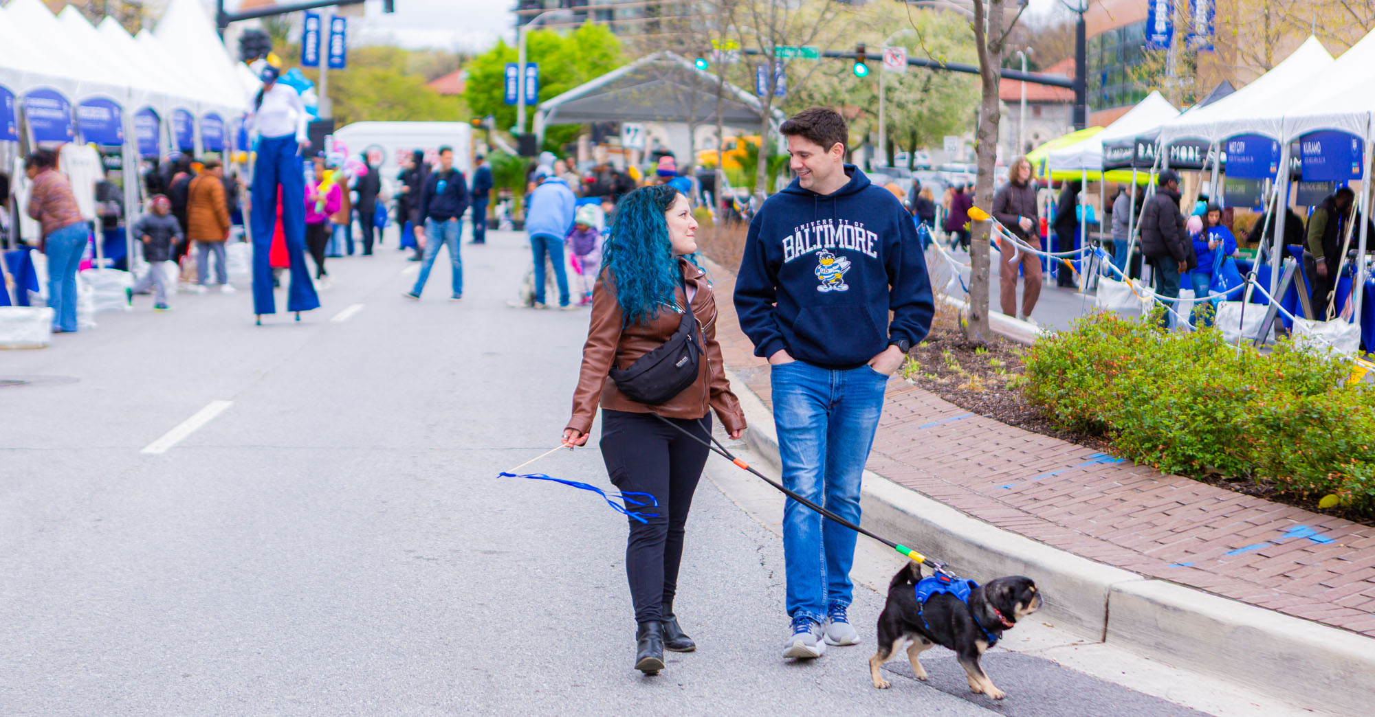 people walk toward the camera at the festival